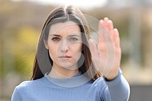 Angry teen gesturing stop in a park