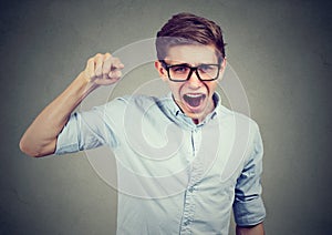 Angry teenager man accusing someone screaming pointing finger photo