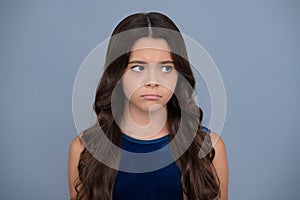 Angry teenager girl, upset and unhappy negative emotion. Little kid girl 12,13, 14 years old on isolated background