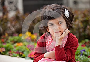 Angry and Thoughtful Little girl in the Garden