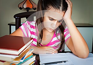 Angry and tired schoolgirl studying