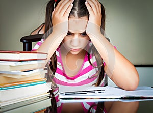 Angry and tired schoolgirl studying photo