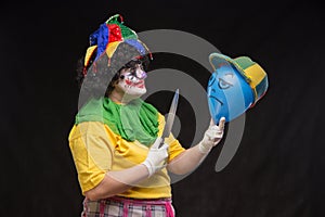 Angry ugly clown wants to kill a balloon in the cap