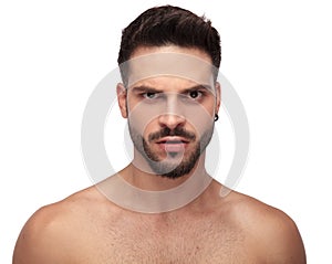 Angry undressed guy looking upset with eyebrow up