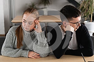 Angry unhappy young couple ignoring not looking at each other after family fight or quarrel, upset thoughtful spouses