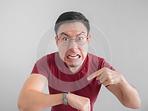 Angry and unpleasant face of man is looking at his watch waiting