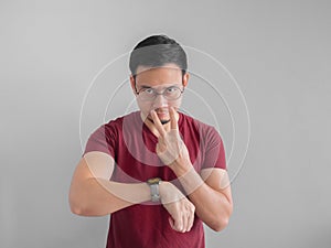 Angry and unpleasant face of man is looking at his watch waiting