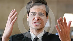 Angry Unsatisfied Businessman Talking with Camera