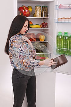 Angry and upset housewife looking into a pot with foul meal