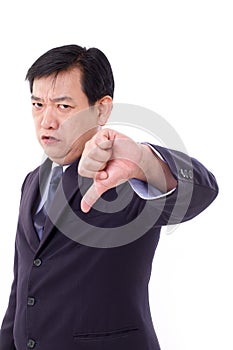 Angry, upset, serious businessman giving thumb down