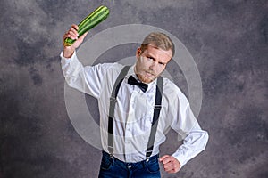 Angry vegetarian minatory with zucchini cudgel