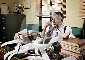 Angry vintage businessman shouting at phone