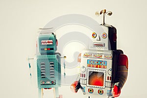 Angry vintage tin toy robots, artificial intelligence, robotic delivery concept