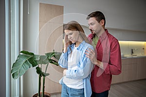 Angry wife turning back to apologizing husband, demonstrating unwilingness to hear, listen, speak