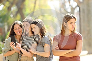 Angry woman being ignored by her friends in the street