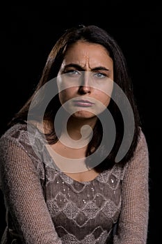 Angry woman on black background