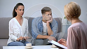 Angry woman blaming husband at psychologist consultation, risk of divorce