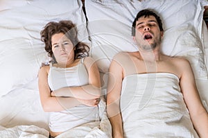 Angry woman cant sleep and listening her husband snoring photo