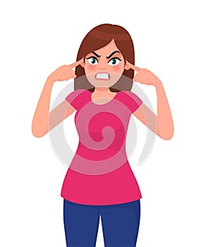 Angry woman covering ears with hands. Girl plugs his ears with his fingers. Fear of loud sounds and unpleasant loud noise. photo
