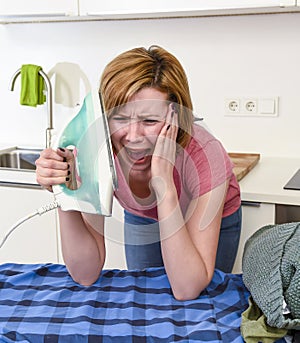 Angry woman or crazy busy housewife ironing shirt lazy at home k