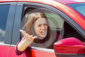 Angry woman driver screaming in the car.