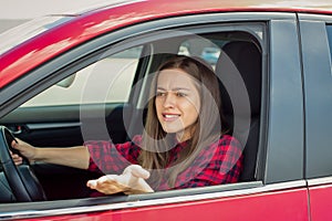 Angry woman driver screaming in the car.