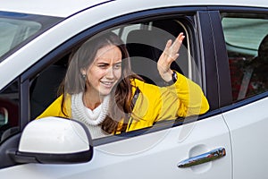 Angry woman driver shows hand gesture to other drivers.