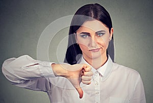 Angry woman giving thumbs down gesture