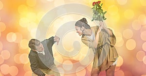 Angry woman hitting man with flowers over blur background