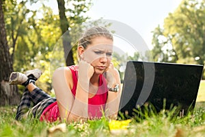 Angry woman looking in laptop