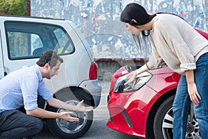 Angry woman and man having quarrel after car crash