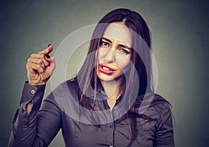 Angry woman pointing her finger accusing someone