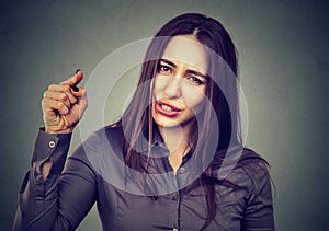 Angry woman pointing her finger accusing someone photo