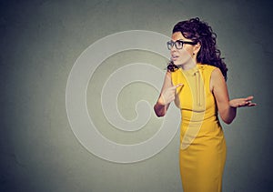 Angry woman pointing at herself in misunderstanding