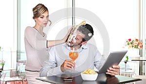 Angry woman pulling cake in face to boyfriend cheating