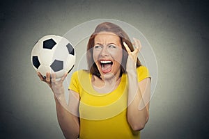 Angry woman screaming at soccer ball