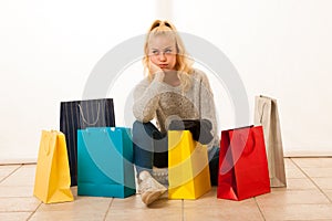 Angry woman with shopping bags after shopping as she spent all t