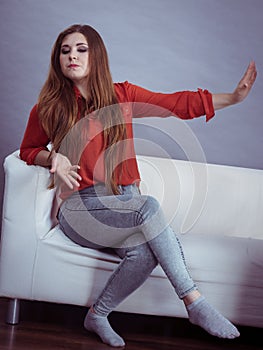 Angry woman sitting on sofa