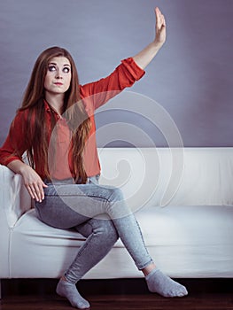 Angry woman sitting on sofa