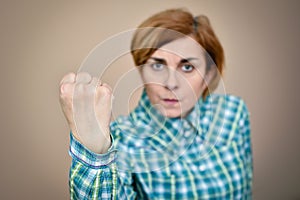 Angry woman threatening with her fist