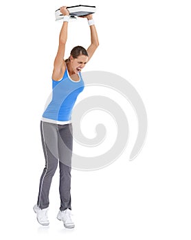 Angry woman, weight loss and throwing scale on ground isolated on a white studio background. Frustrated female person