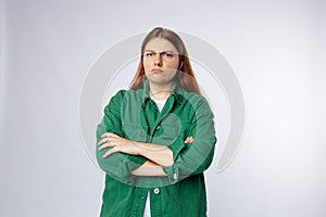 Angry young 30s woman standing isolated over white background. Emotional, young face. Human emotions, facial expression
