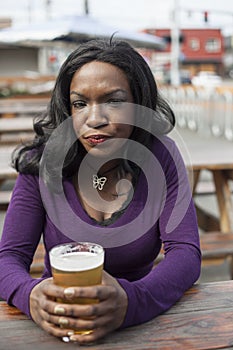 Angry Young African American Woman Drinks Pint of Pale Ale