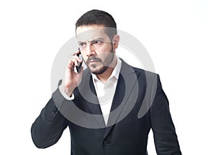 Angry young businessman on the phone.