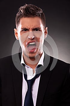 Angry young businessman shouting