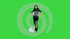 Angry young businesswoman tearing paper on a Green Screen, Chroma Key