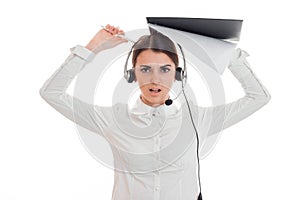 Angry young call center office girl with headphones and microphone looking at the camera and screaming isolated on white