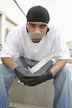 Angry Young Criminal Holding Knife