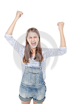 Angry young fashion girl in jeans overalls screaming isolated
