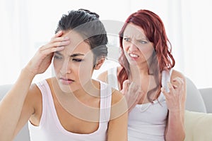 Angry young female friends having an argument photo